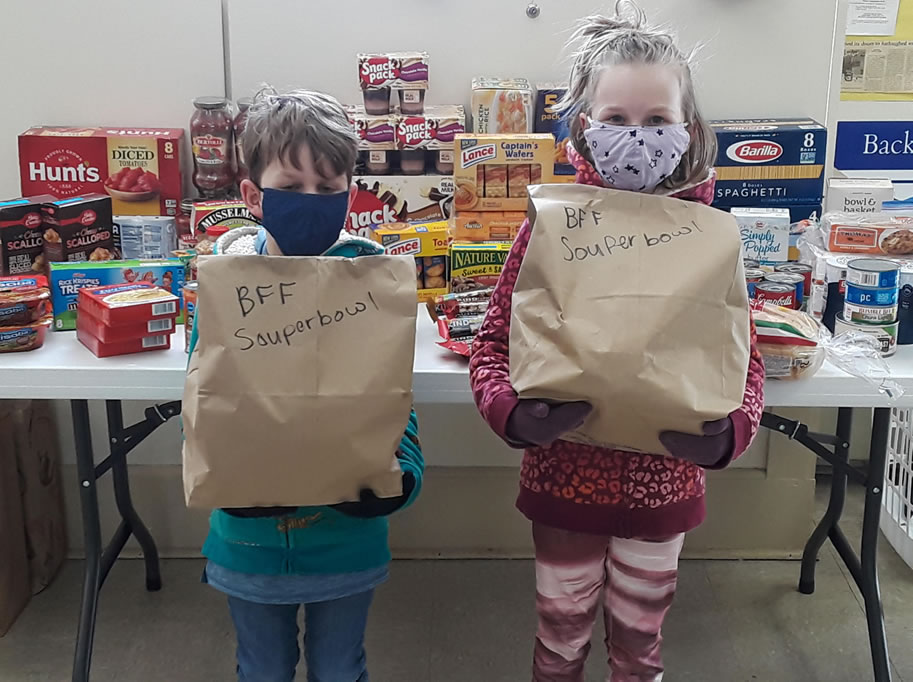 children bring donations for souper bowl Sunday